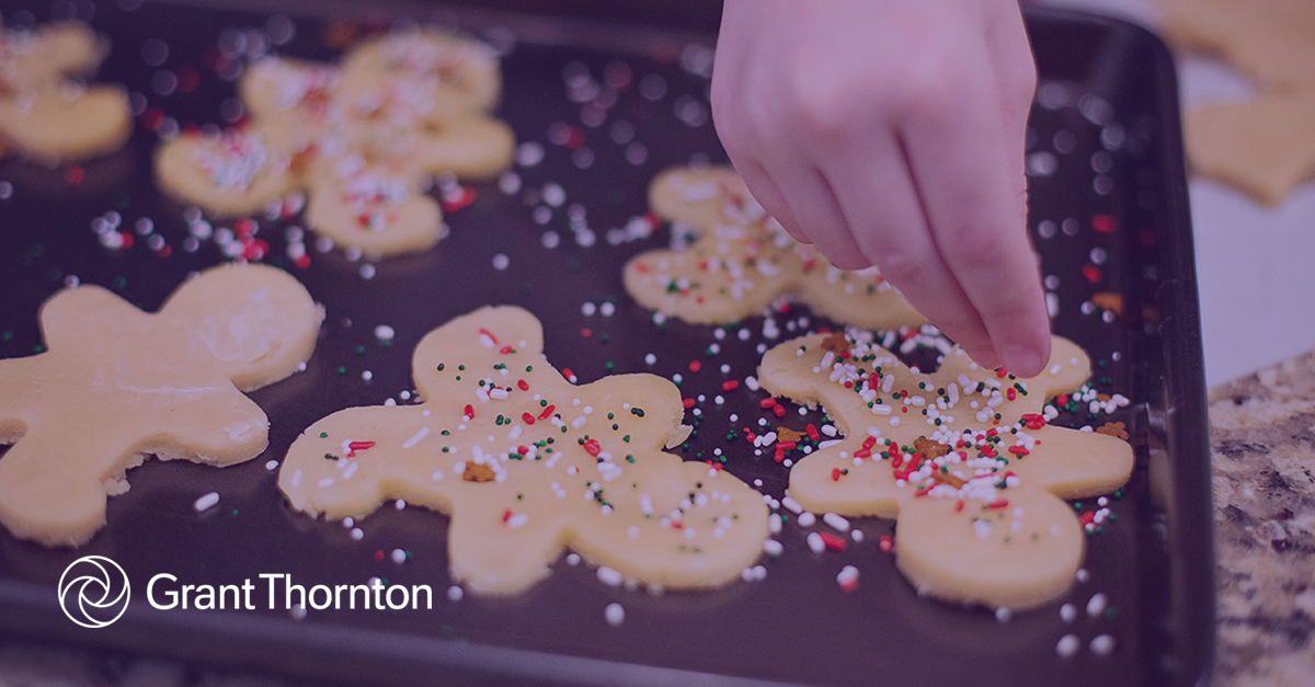 Gingerbread cookies being covered in sprinkles