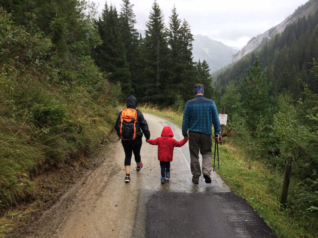 Family of three on an alpine hike. 